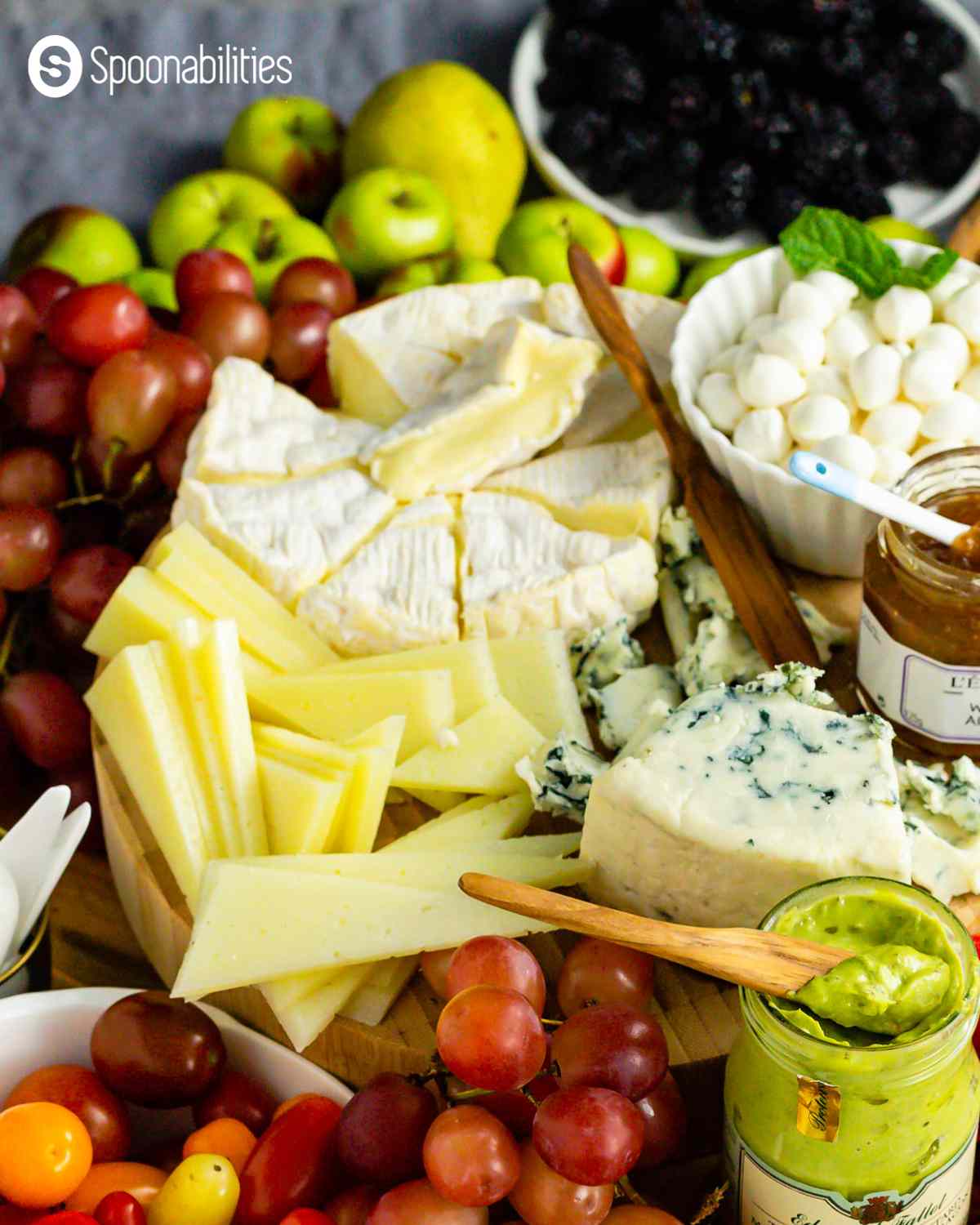 Charcuterie board cheeses with fruits and spreads