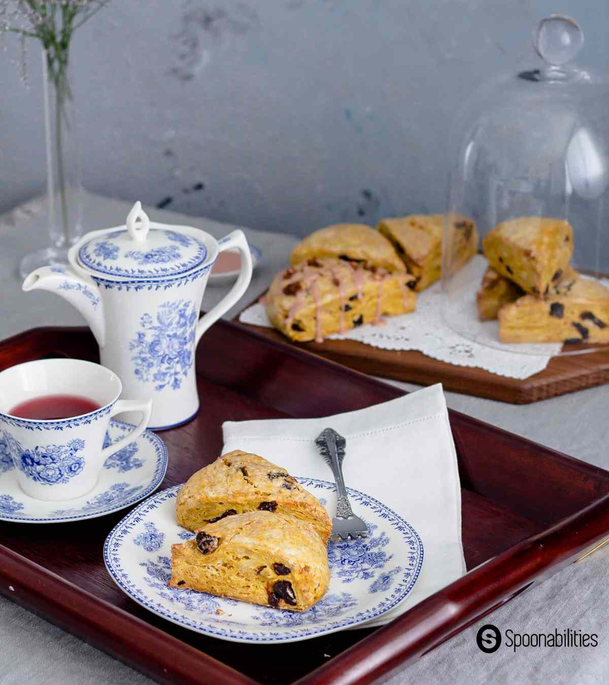 Pumpkin scones served with tea in a cup and teapot on a tray