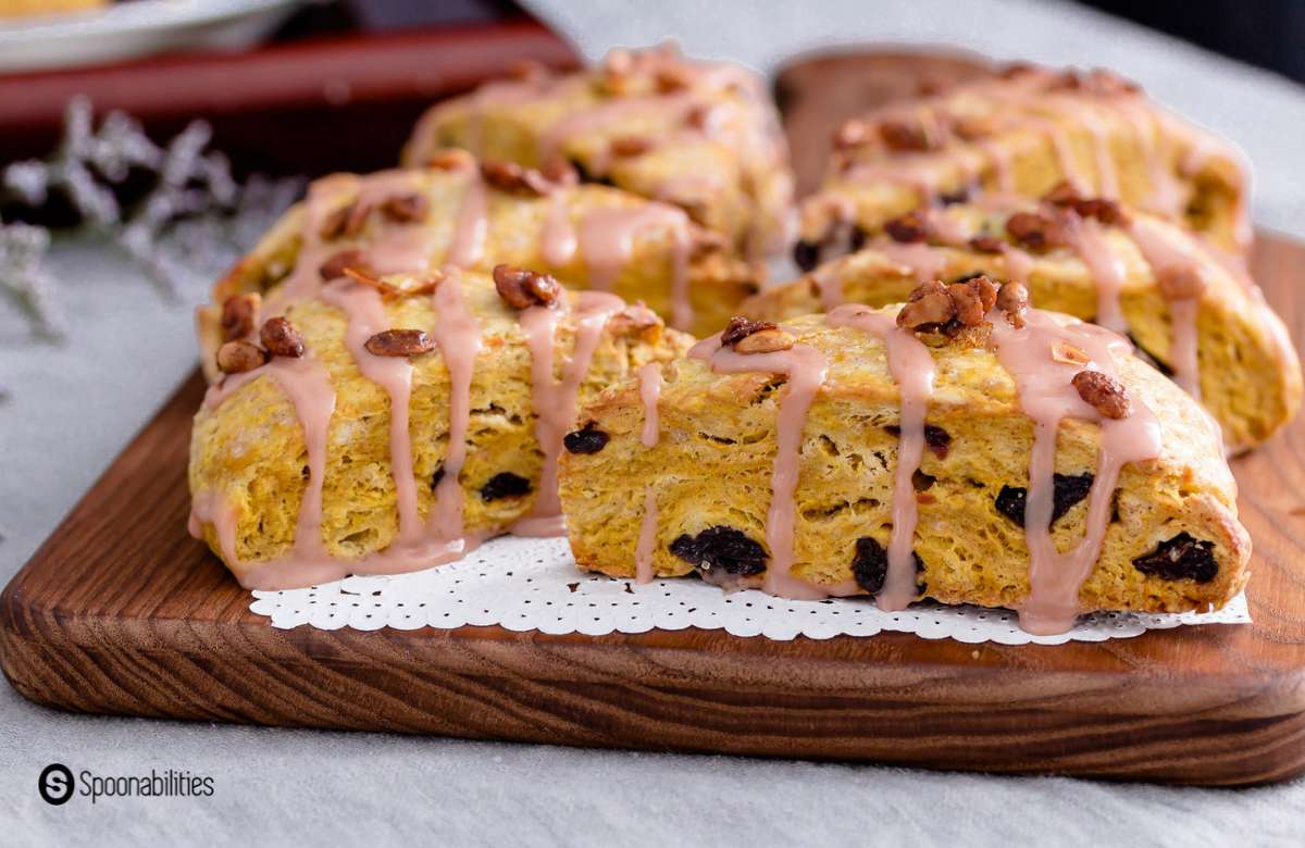 Pumpkin scones cut into six wedges and arranged on a wooden chopping board