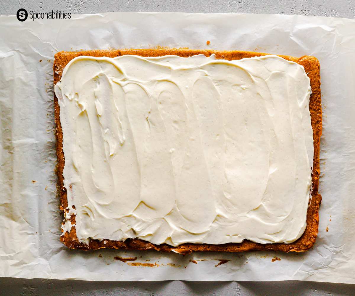 Pumpkin cake with generous amount of cream cheese filling spread on top