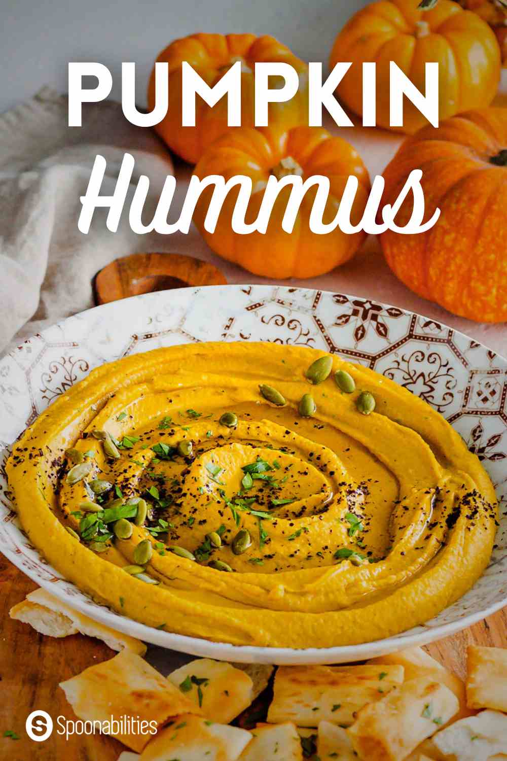 Pumpkin hummus in a white plate with gold accents