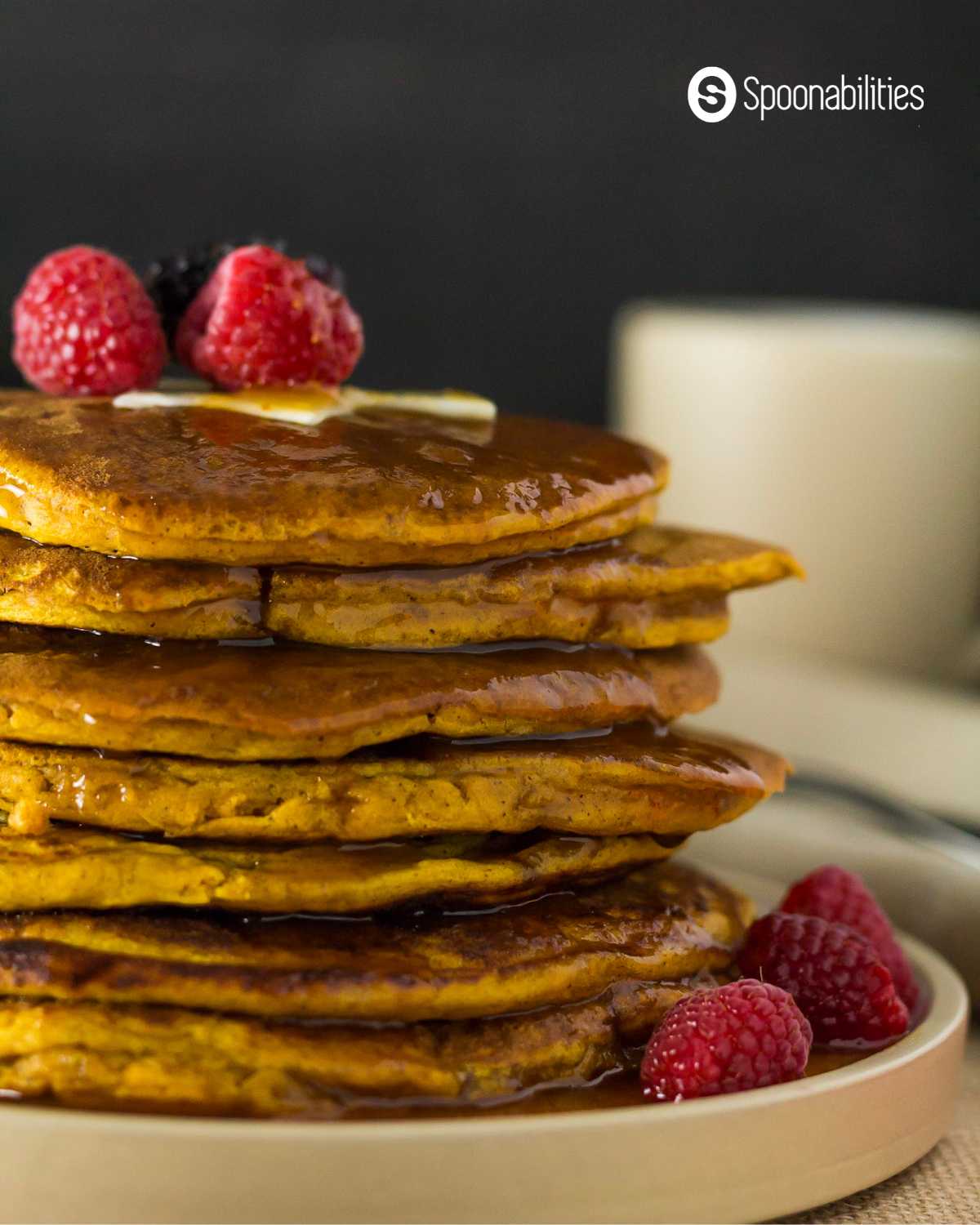 Pumpkin Pancakes stacked and drenched in syrup