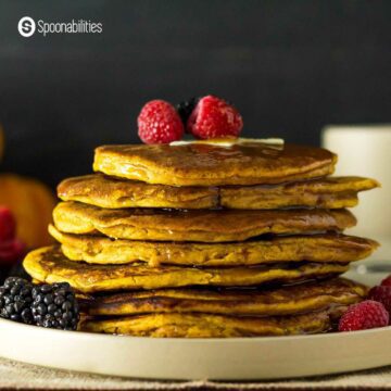Spiced pumpkin pancakes with berry toppings and syrup