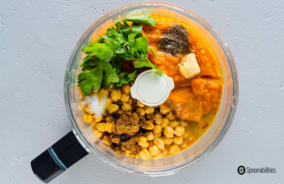 pumpkin hummus ingredients arranged inside a food processor bowl