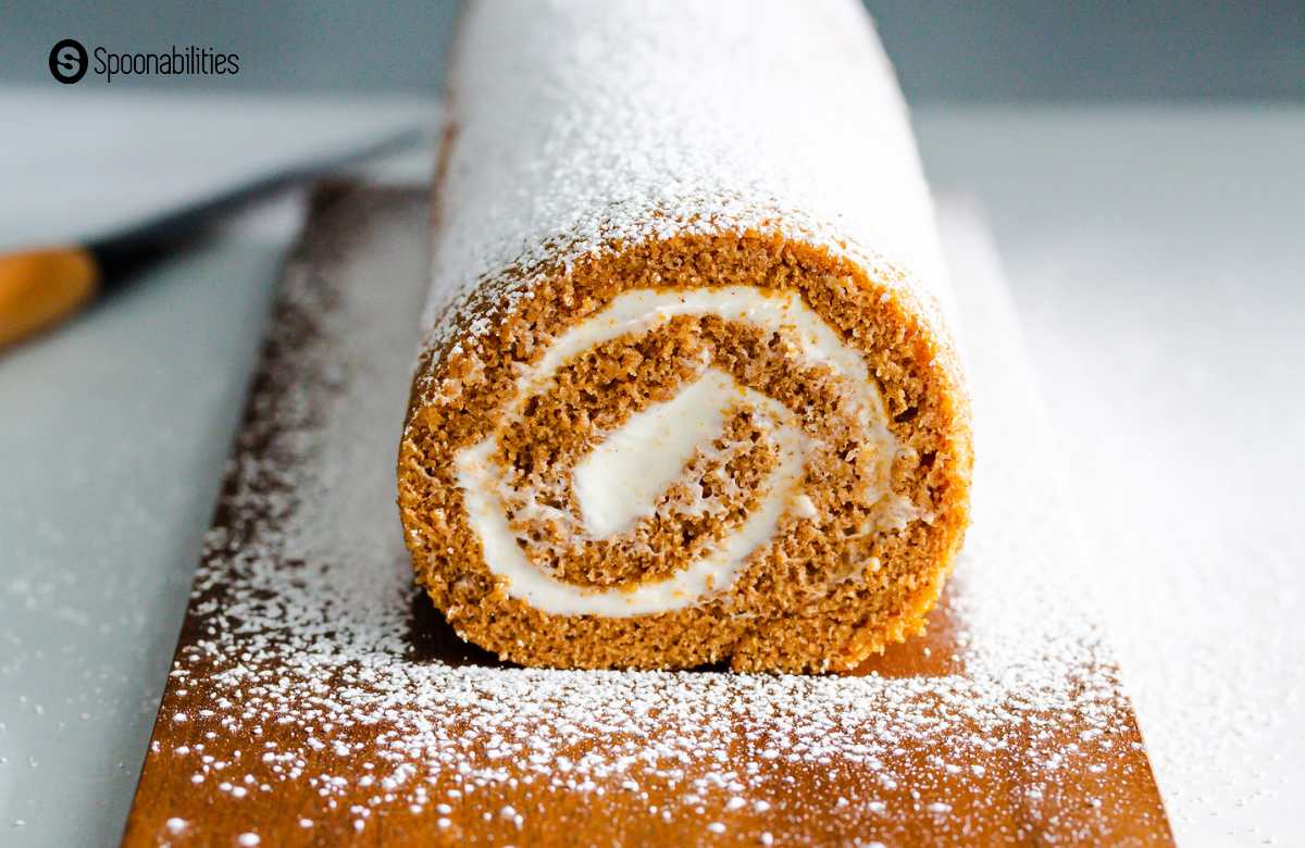 Cross section of pumkin roll showing swirl of cream cheese filling