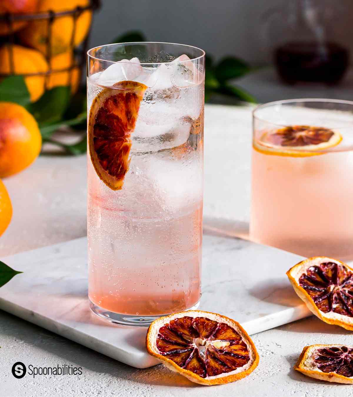 Blood orange vodka soda cocktail in a tall clear glass with plenty of ice