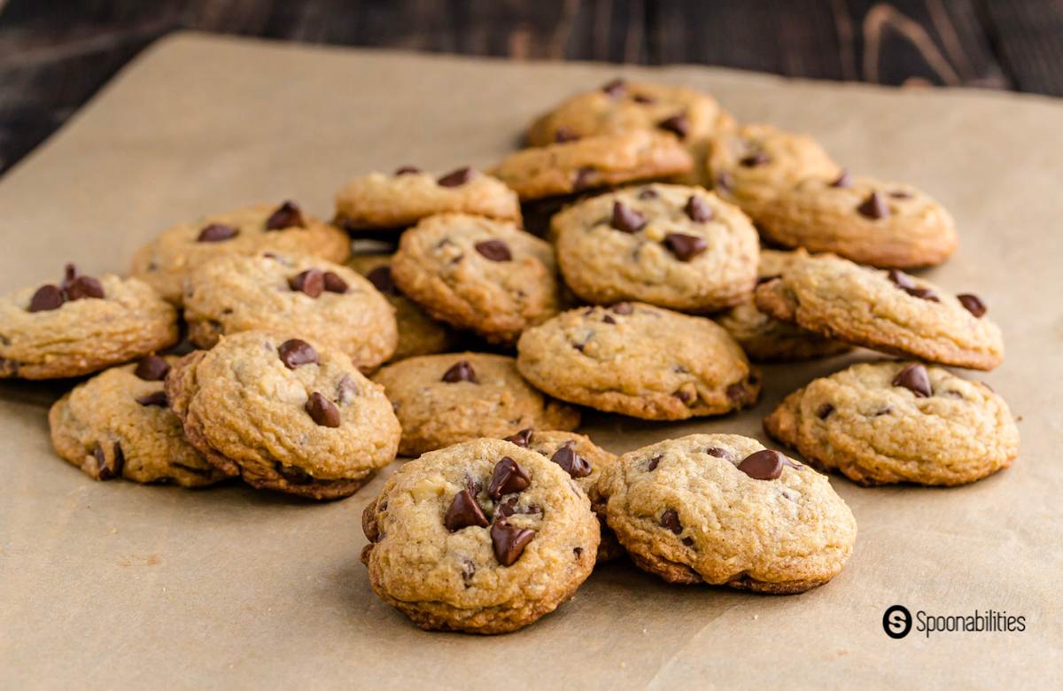 A bunch of chocolate chip cookies on parchment paper