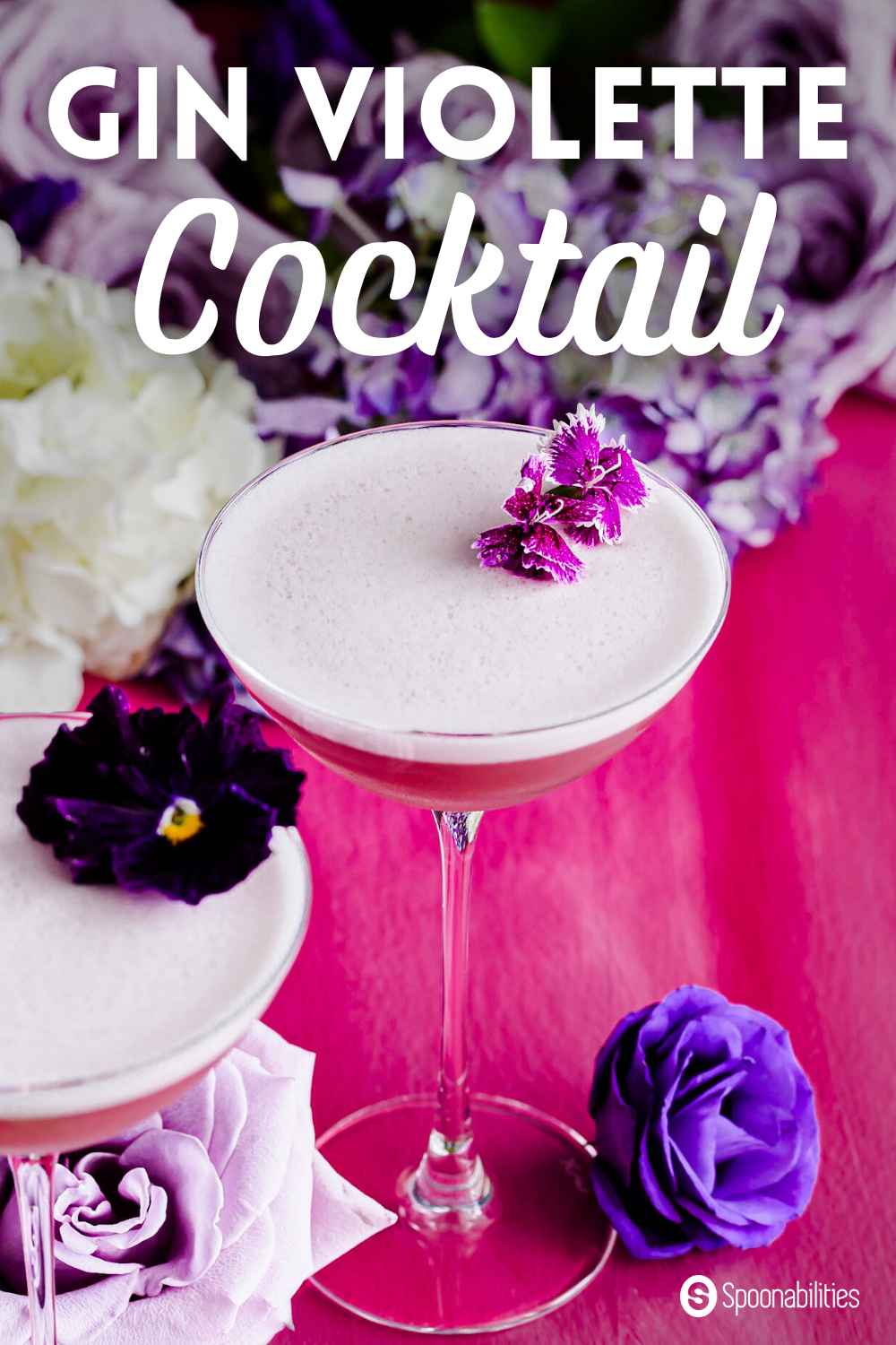 Gin violette cocktail with violet colored flower garnish