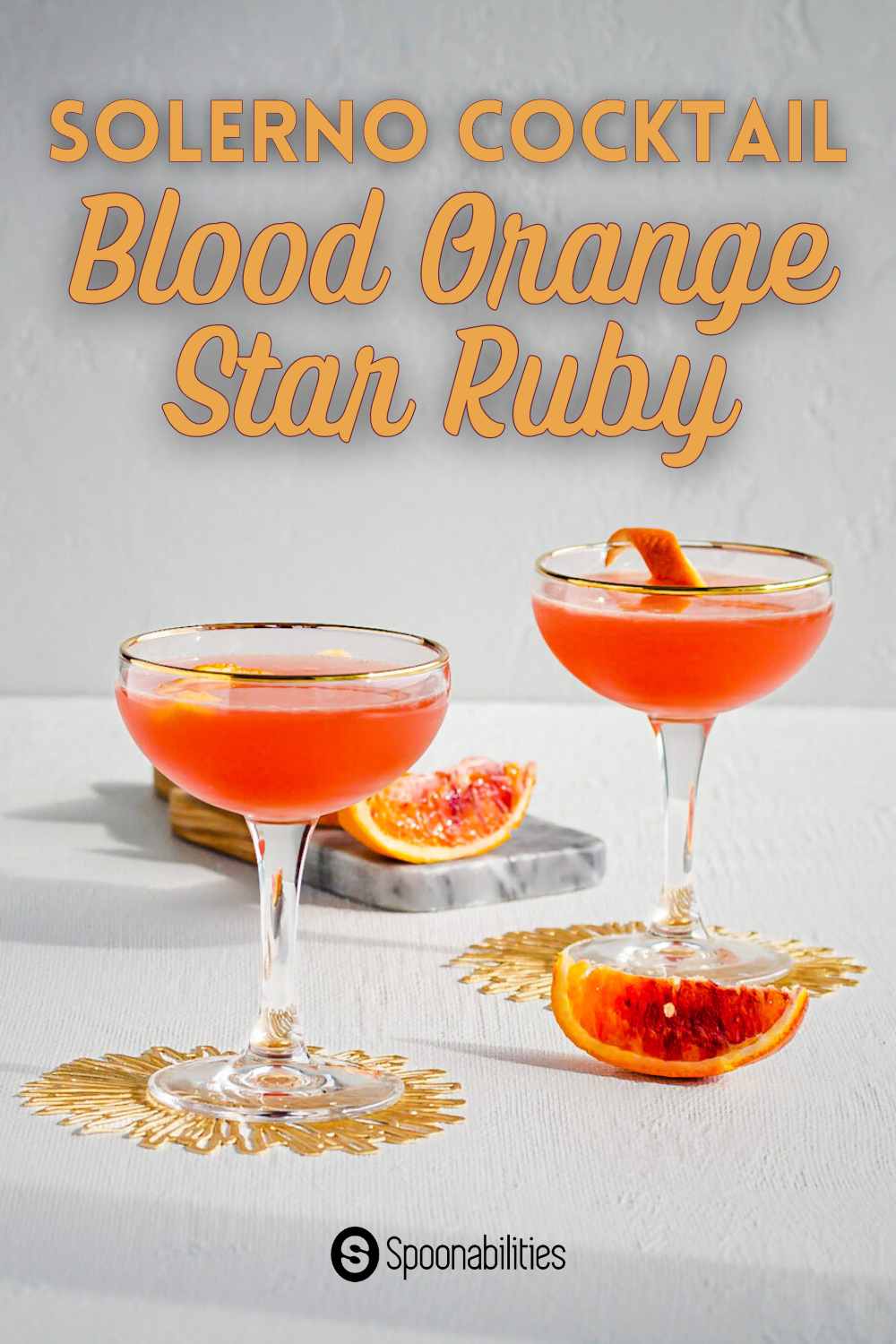 Blood orange solerno cocktails with blood orange zest as garnish and blood orange wedges