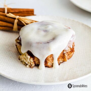 Sourdough cinnamon roll with frosting on a plate