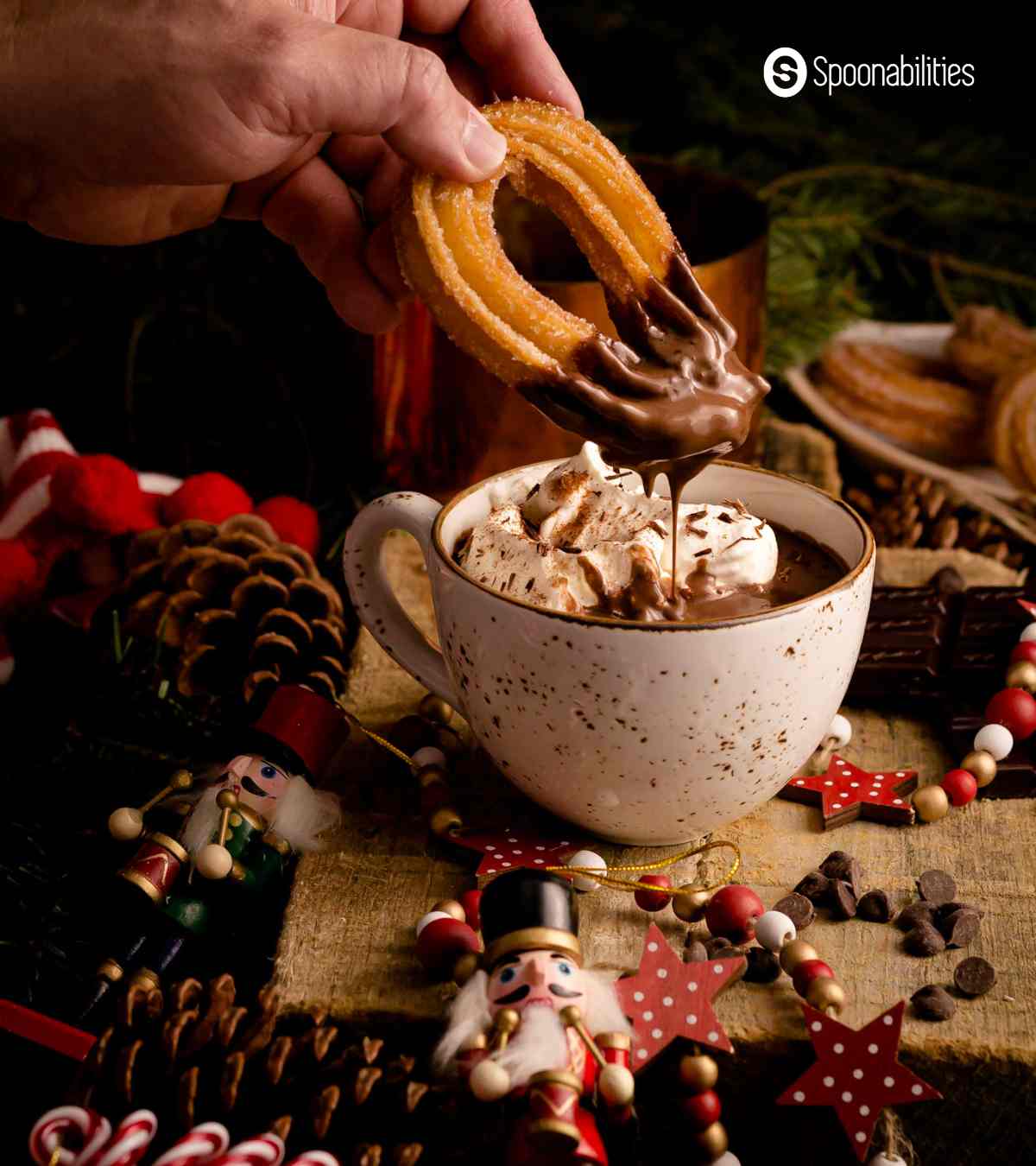 Dipping churros into a cup of Spanish hot chocolate